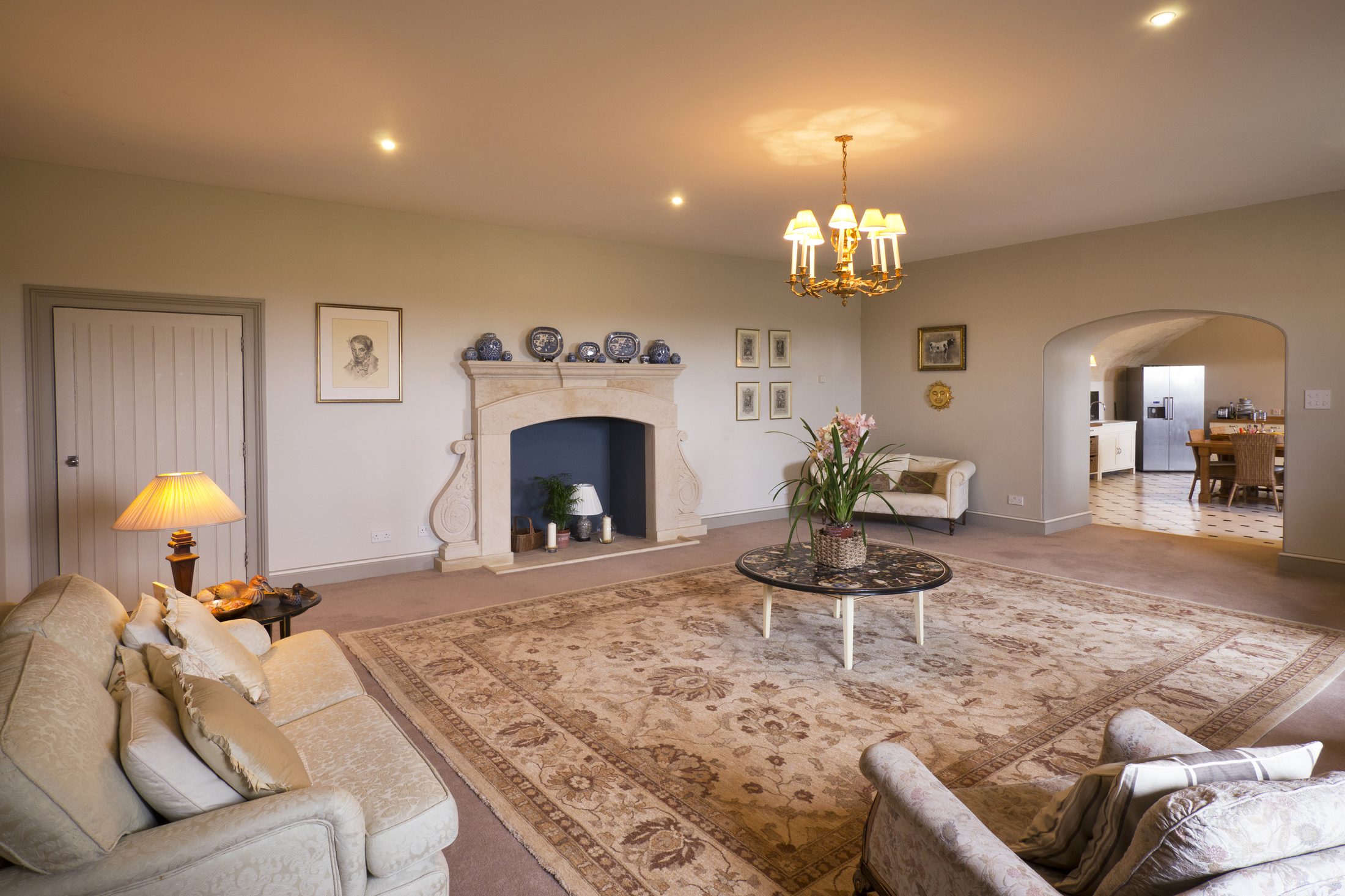 The Family Room, with a stone fireplace and a patterned rug