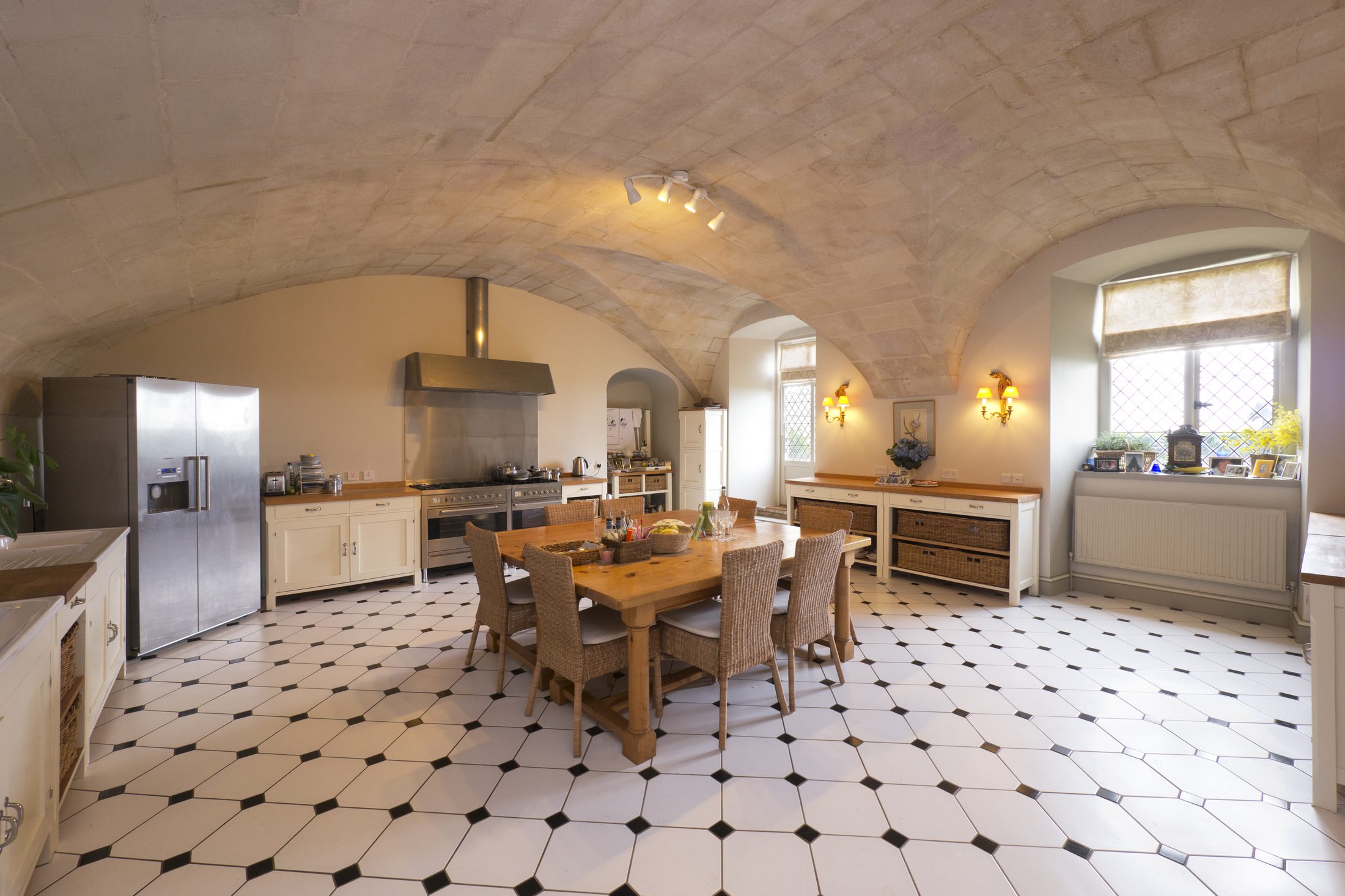 The stone-vaulted Kitchen, with a commercial gas range and twin double sinks