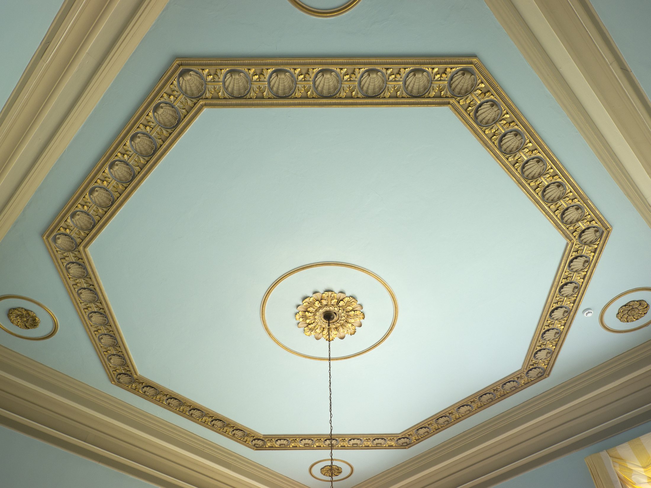 A painted ceiling roundel in pale green and gold, in the Library
