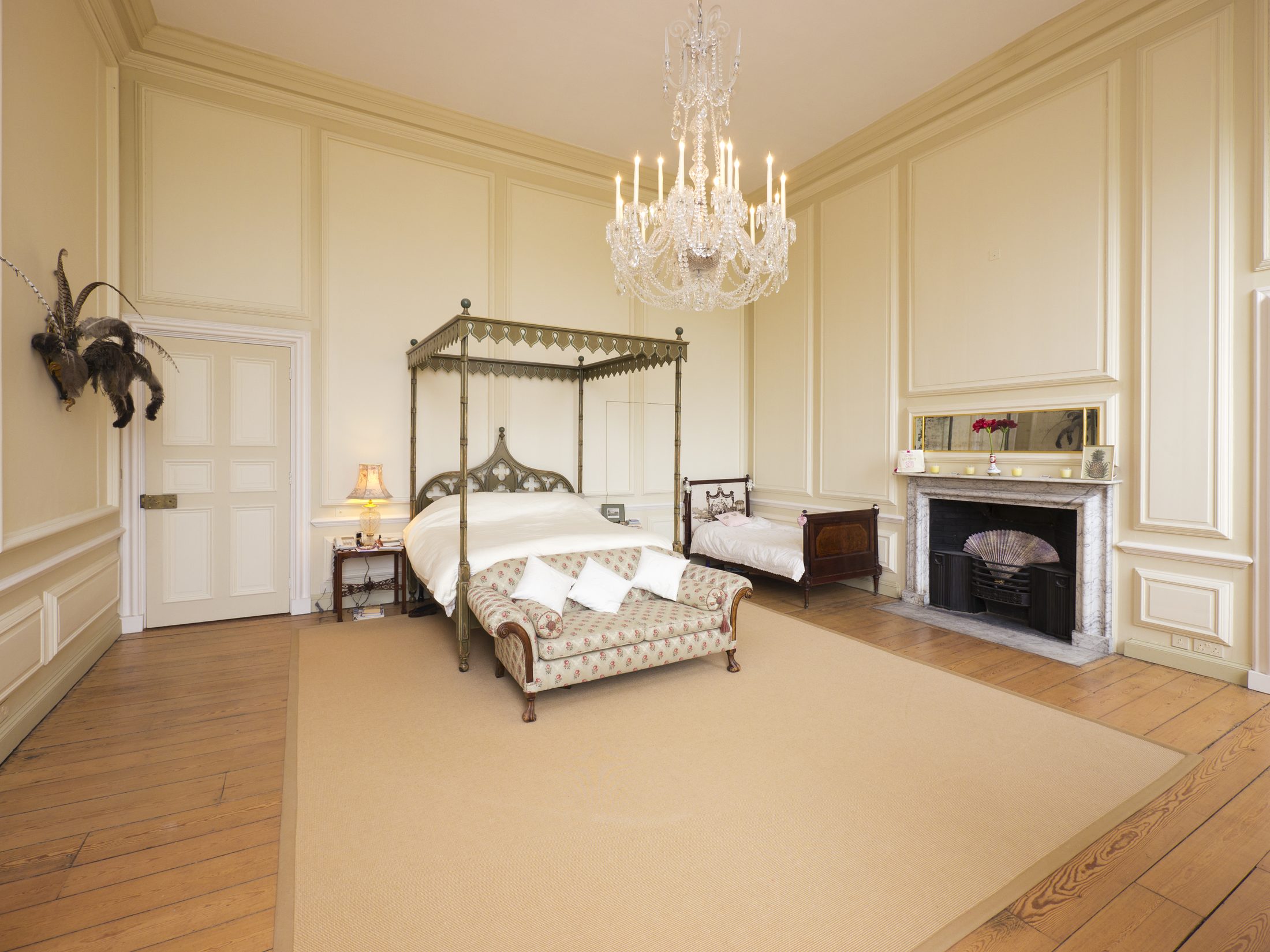 The State Bedroom, with a four-poster bed and marble fireplace