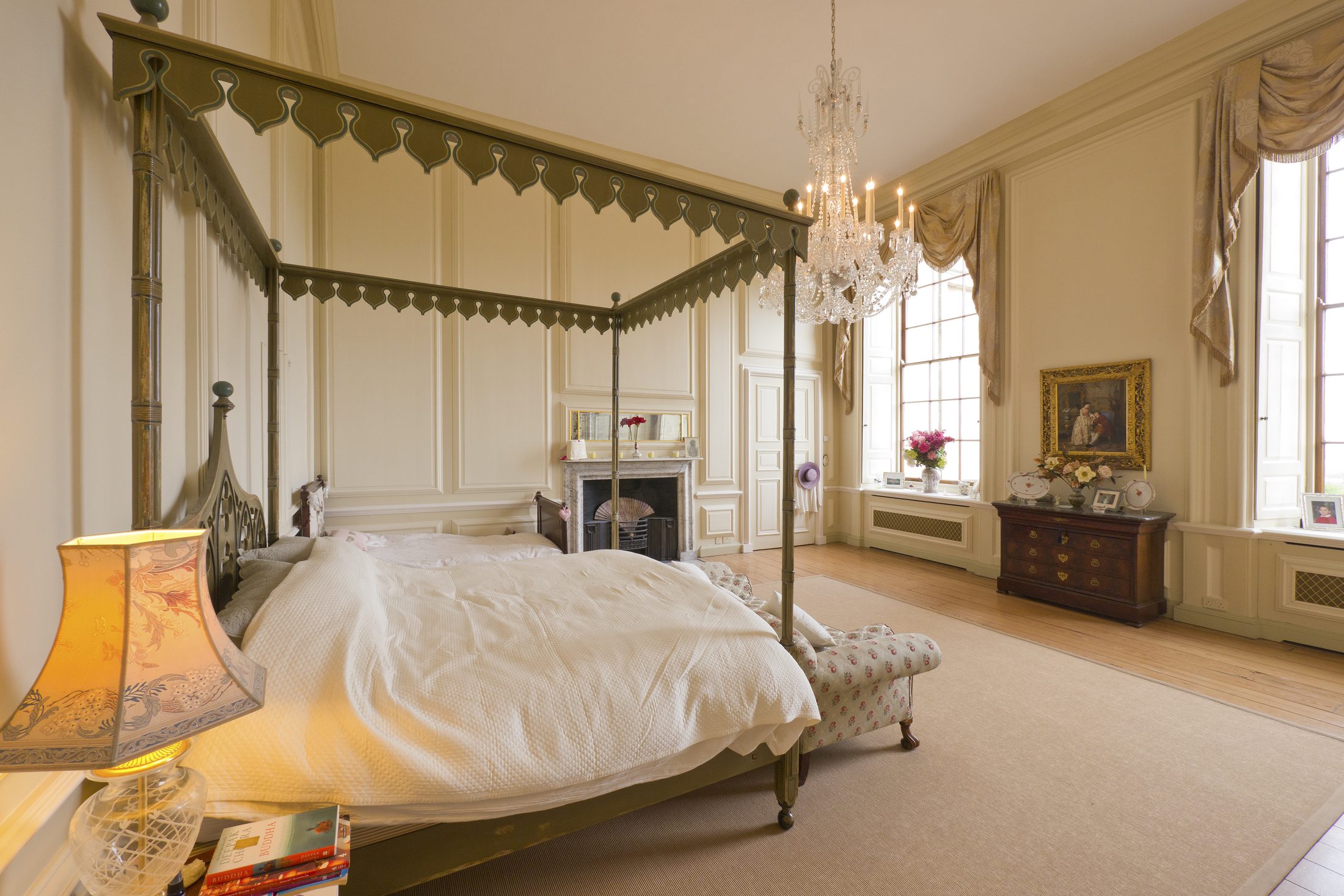 The State Bedroom, with a canopied four-poster bed and chandelier