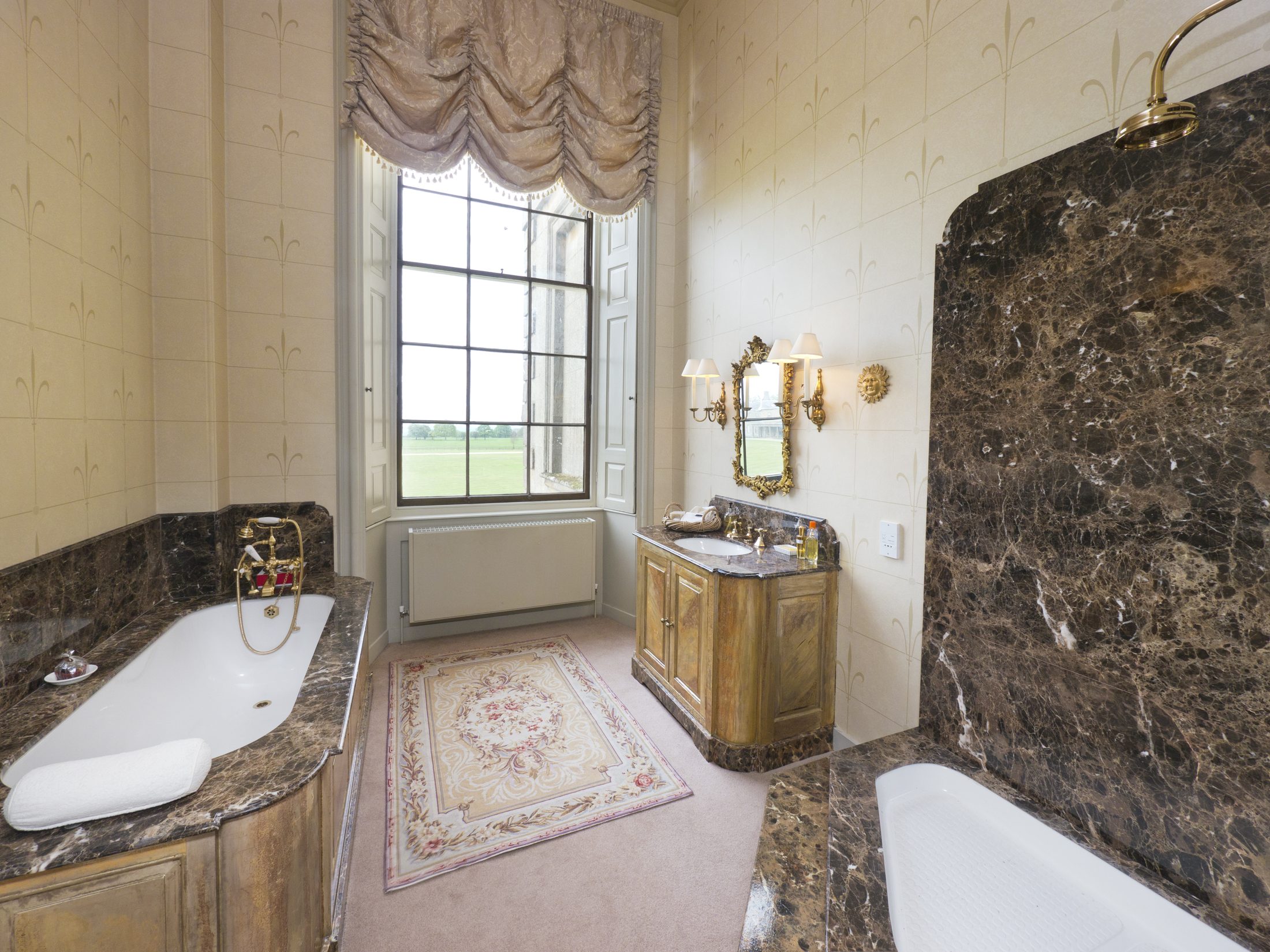 Bathroom 1, with a marble surround and roll-top bath
