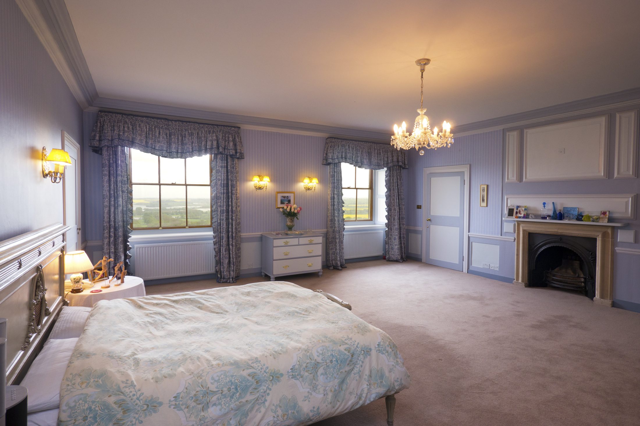 Bedroom 2, another view, with lilac walls and a chandelier