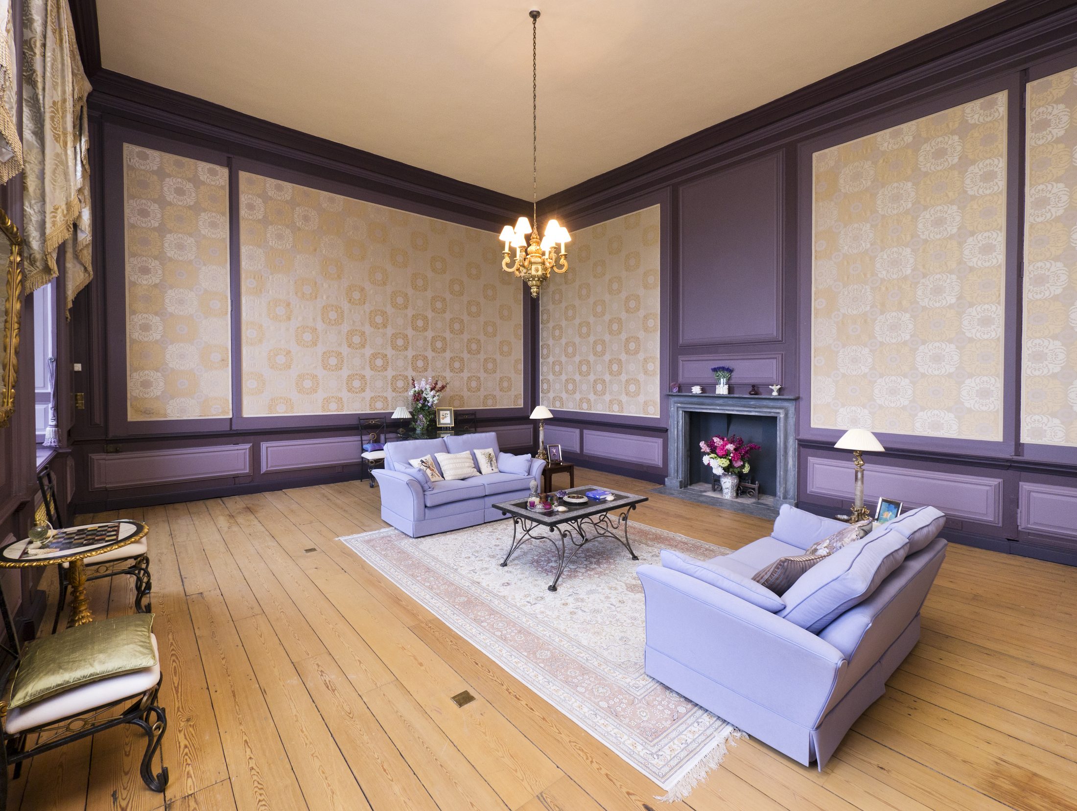 The Purple Sitting Room, with striped wallpaper and lilac upholstery