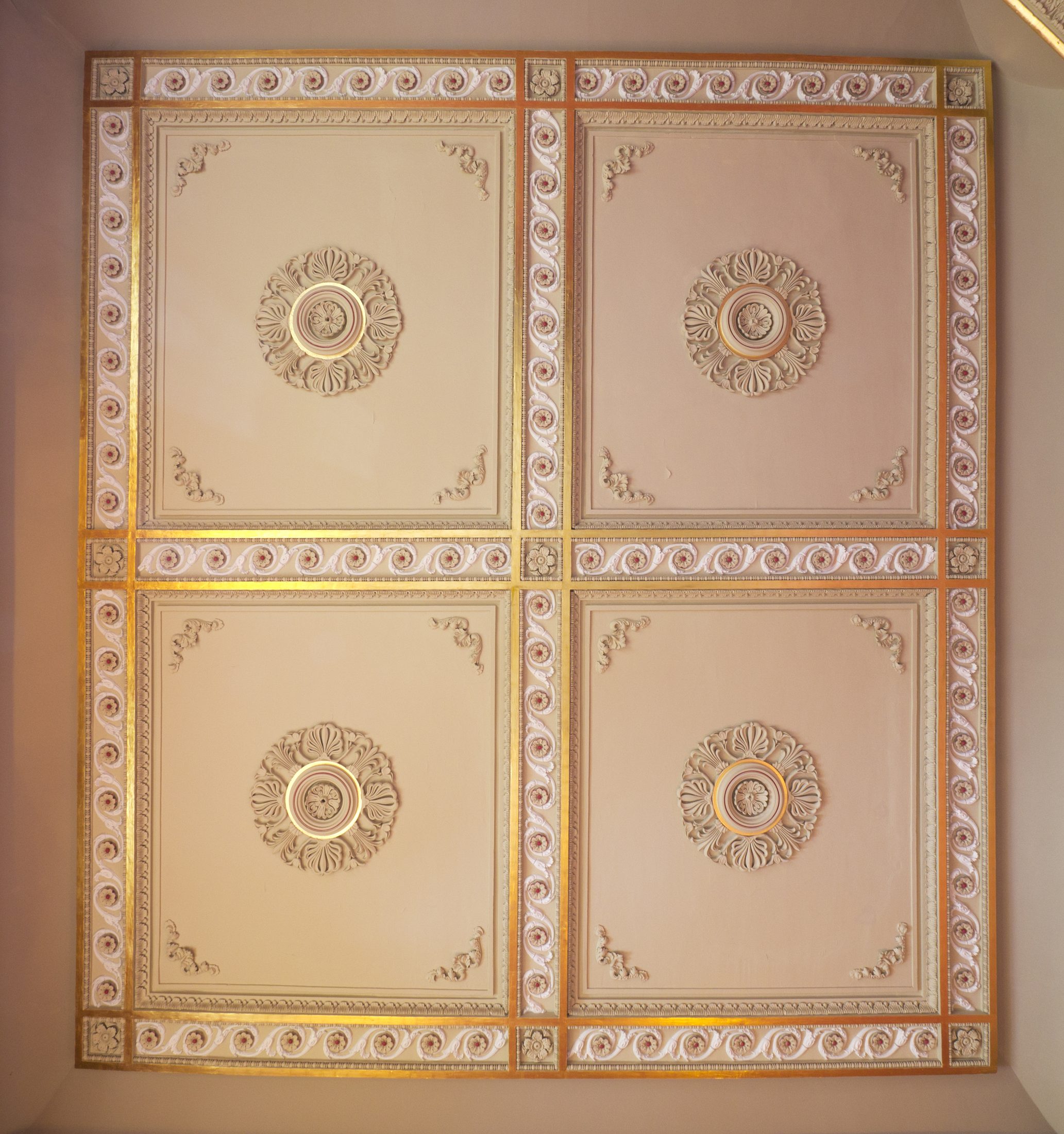 A coffered ceiling picked out in cream and gold, in the Dining Room