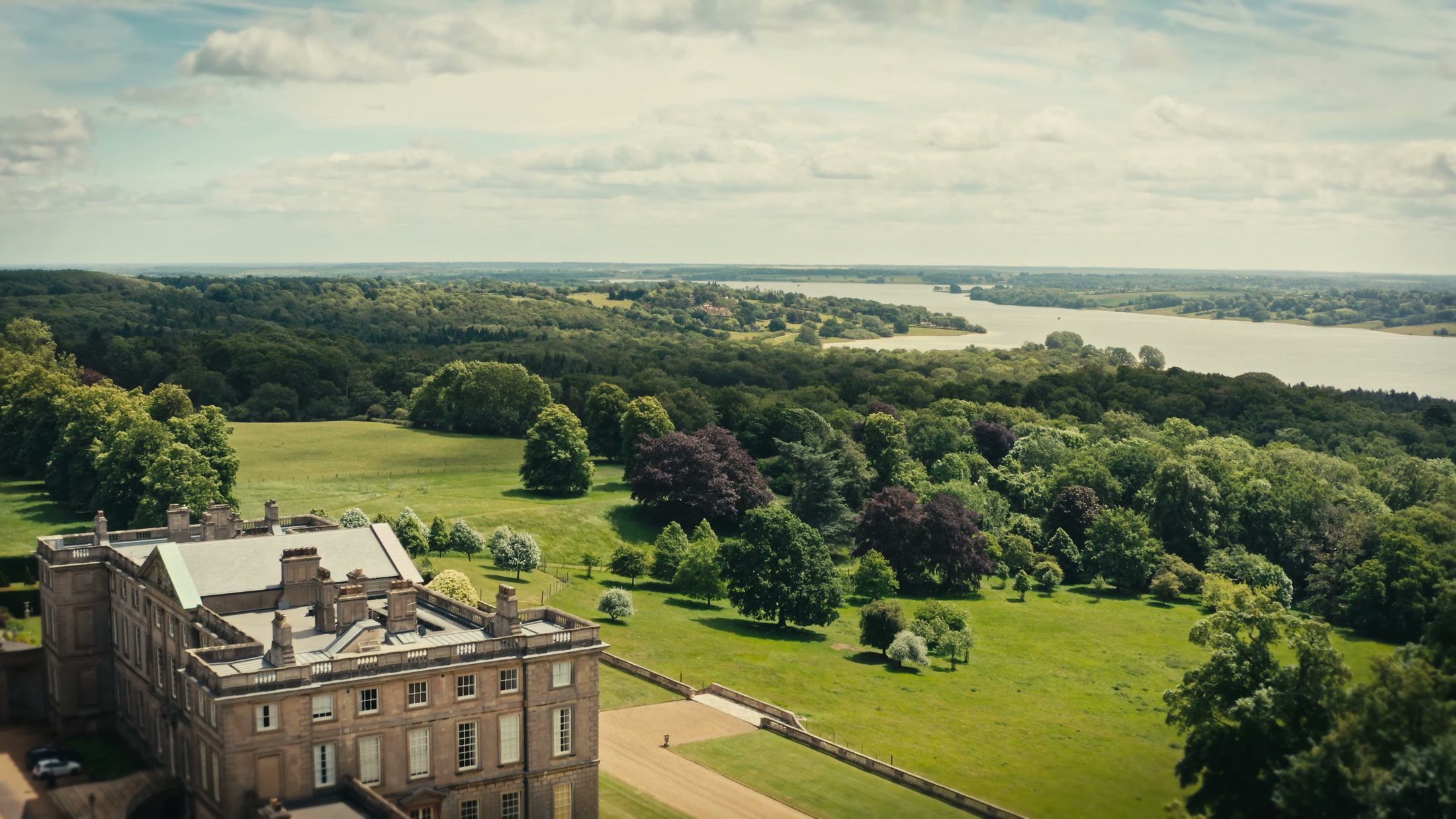 Aerial view from above the house looking south across the parkland to Rutland Water on the horizon